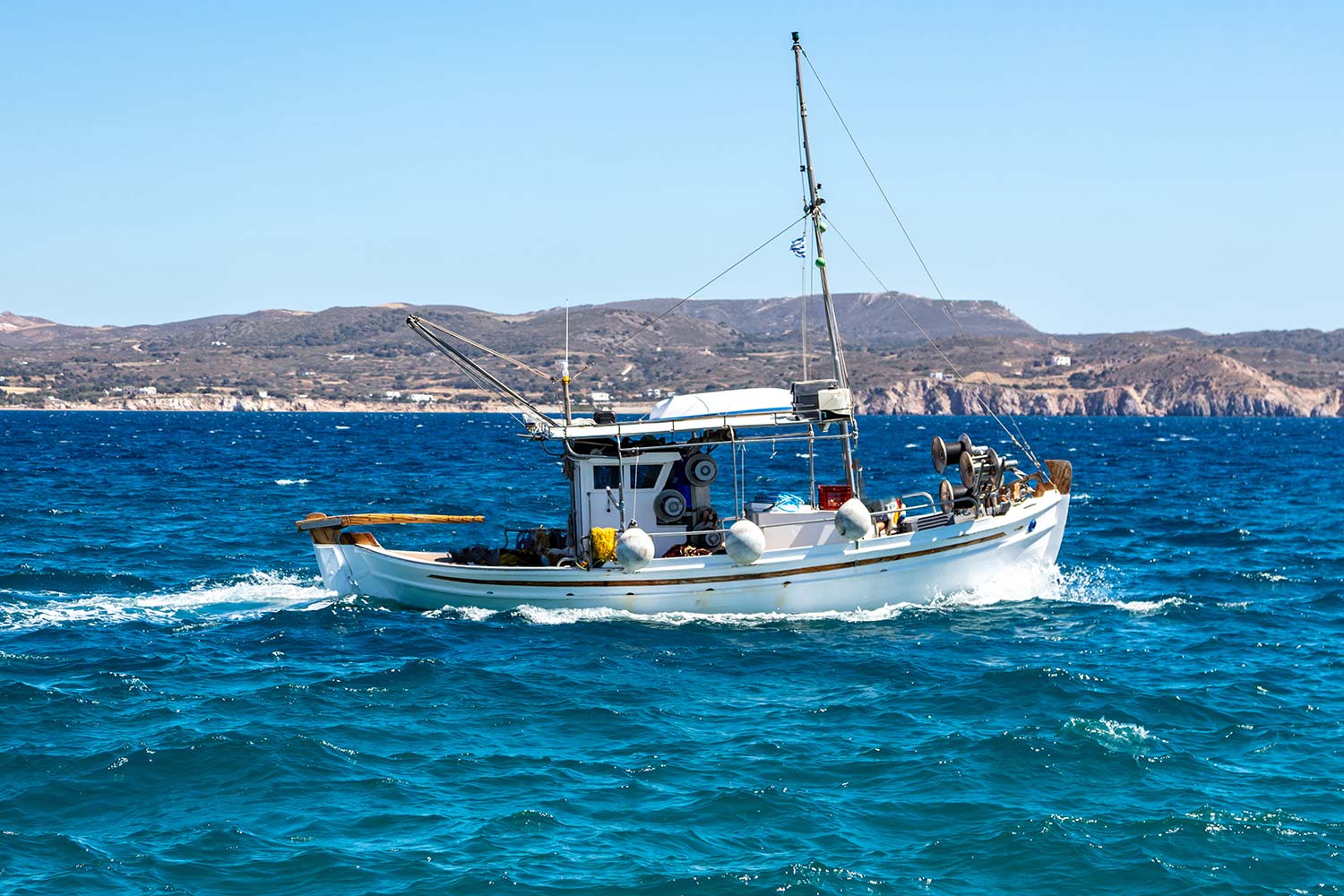 fishing-boat-moving-in-wavy-sea-cyclades-greece-resize.jpg